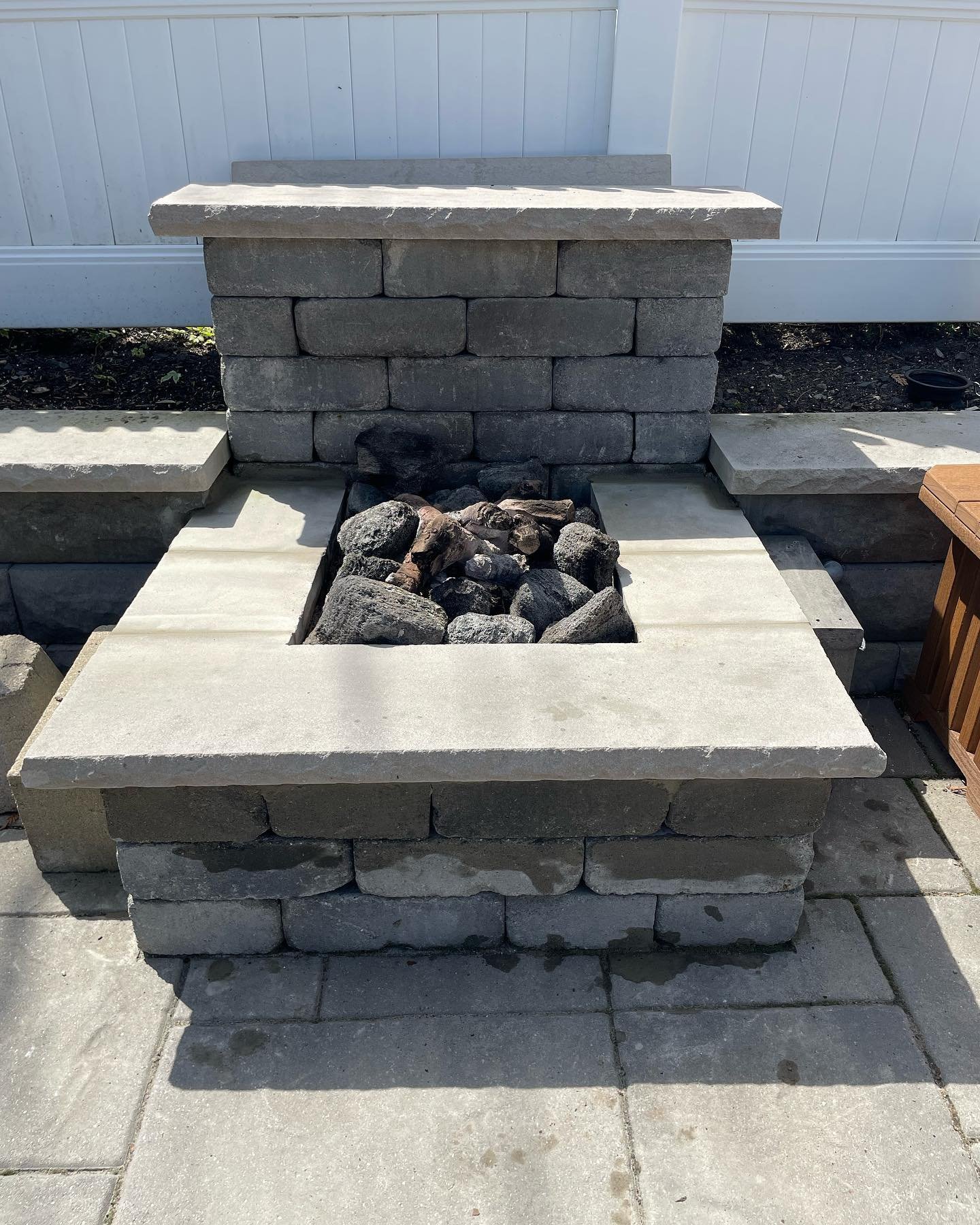 The restored gray top surround fitted around the central fire opening.