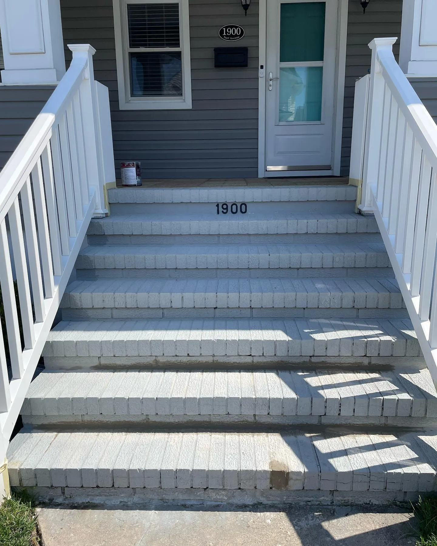 Earlier: the entrance steps with visible masonry joints, worn gray surfaces and a differently colored patch at the lowest step.