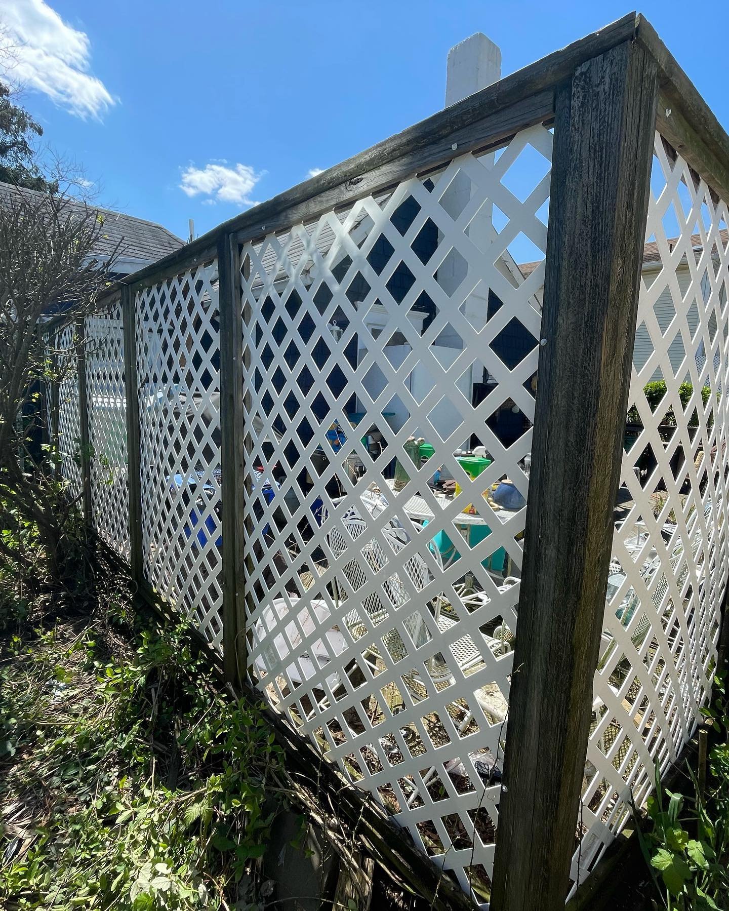 Before: weathered timber posts and top rails around the terrace lattice fence.