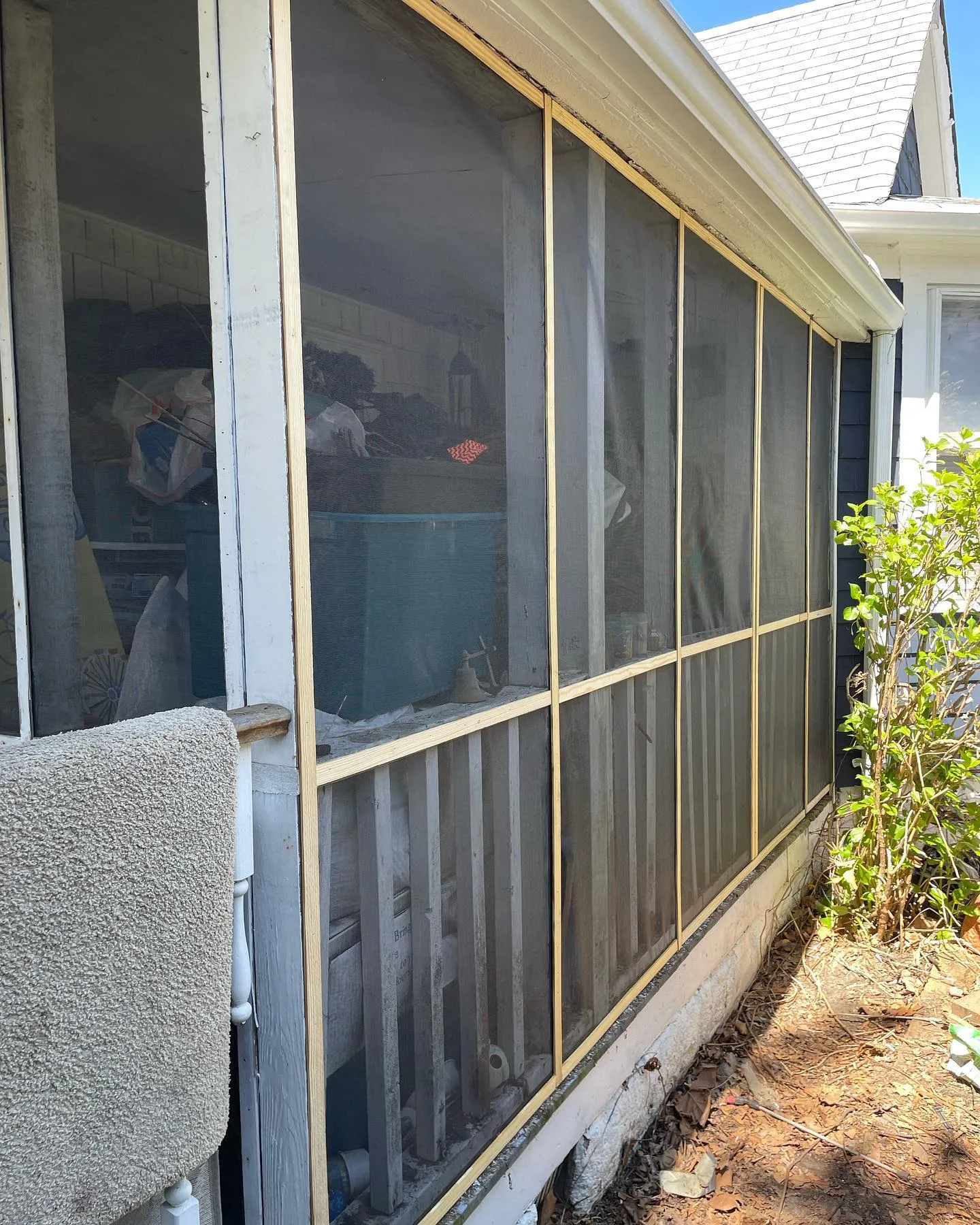 After: new screening across the porch openings, viewed from the garden.