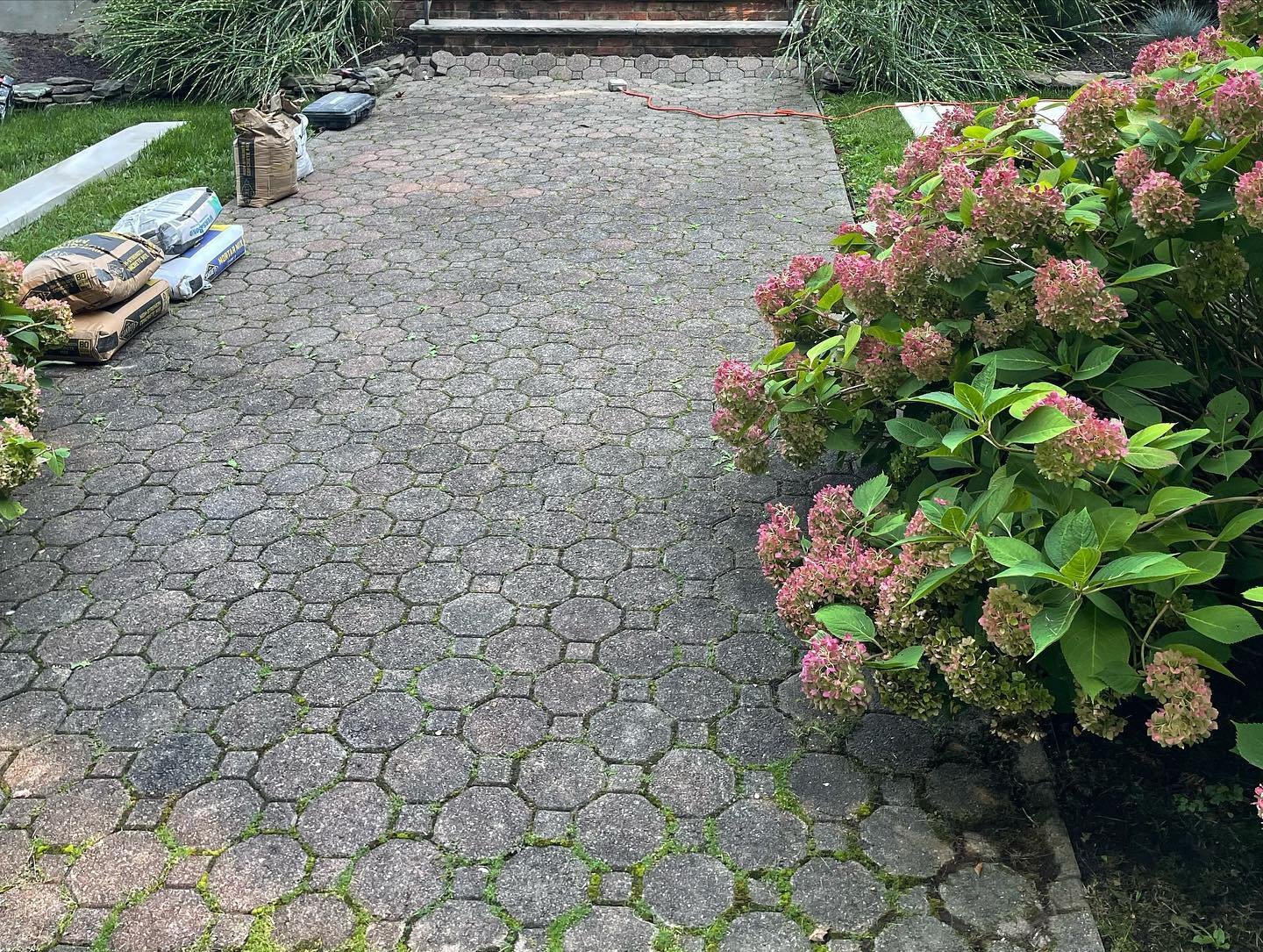 Before: the old small patterned paving units along the front garden walkway.