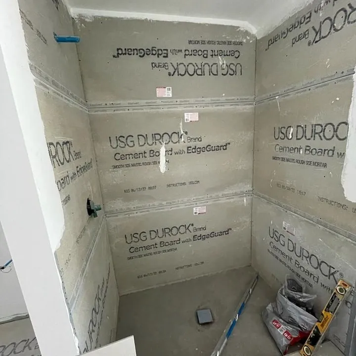 The cement-board shower walls and base before the tile finish covered the backing.