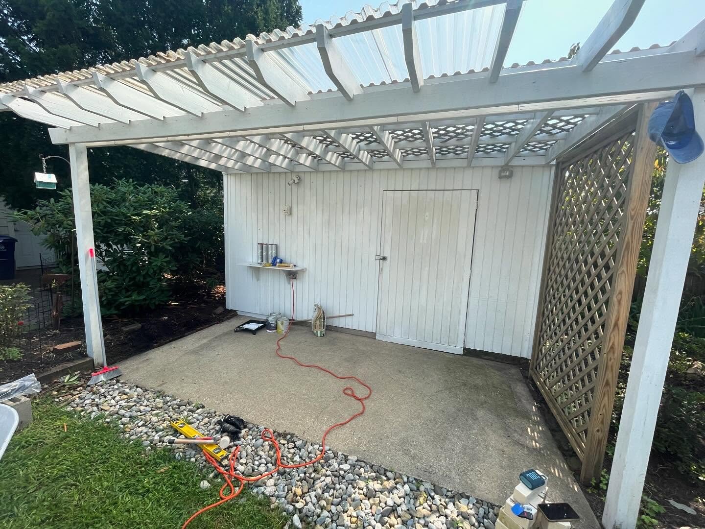 Before: the covered grill pad and lattice screen before the new block walls and caps.