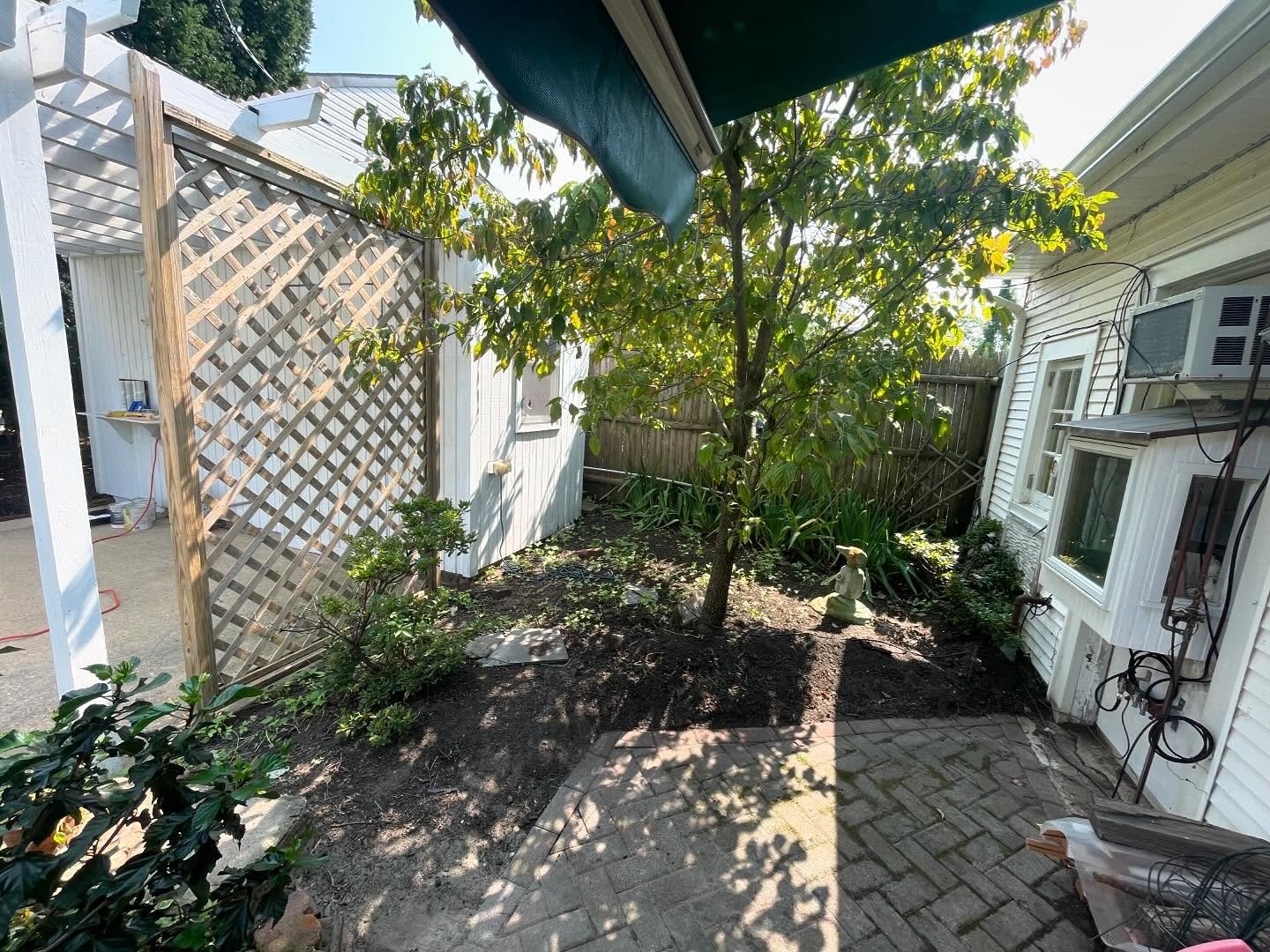 Before: the garden bed beside the paver path, without the finished block border.