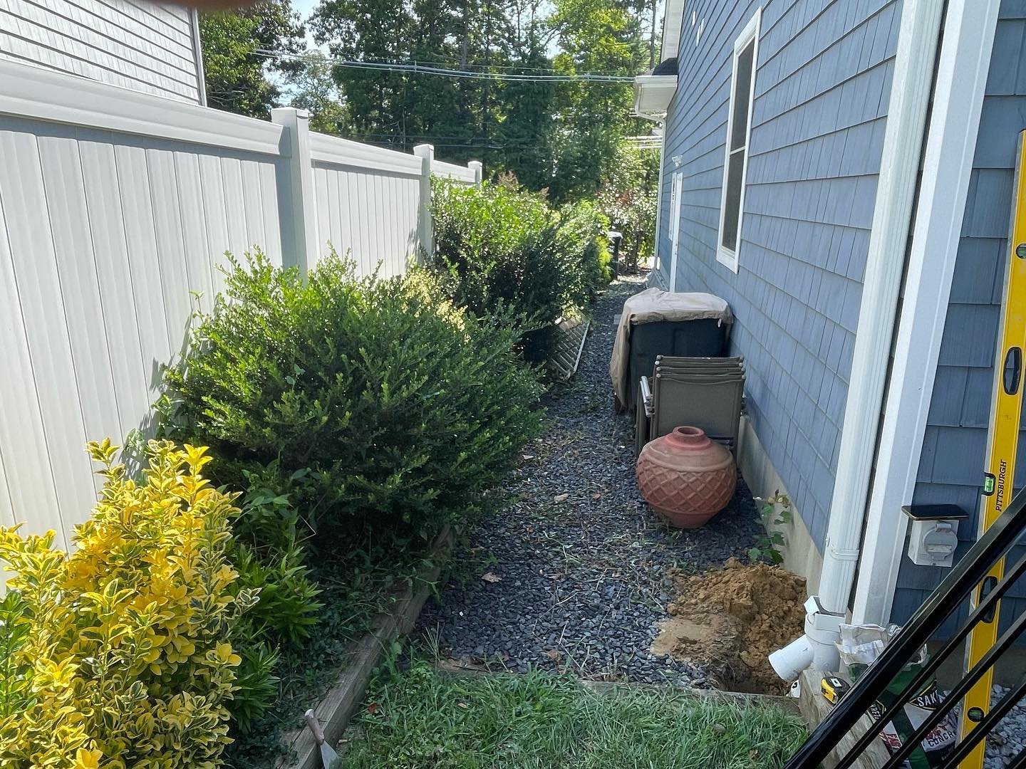 Earlier view of the narrow passage between the house and white boundary fence, before the gate was fitted.