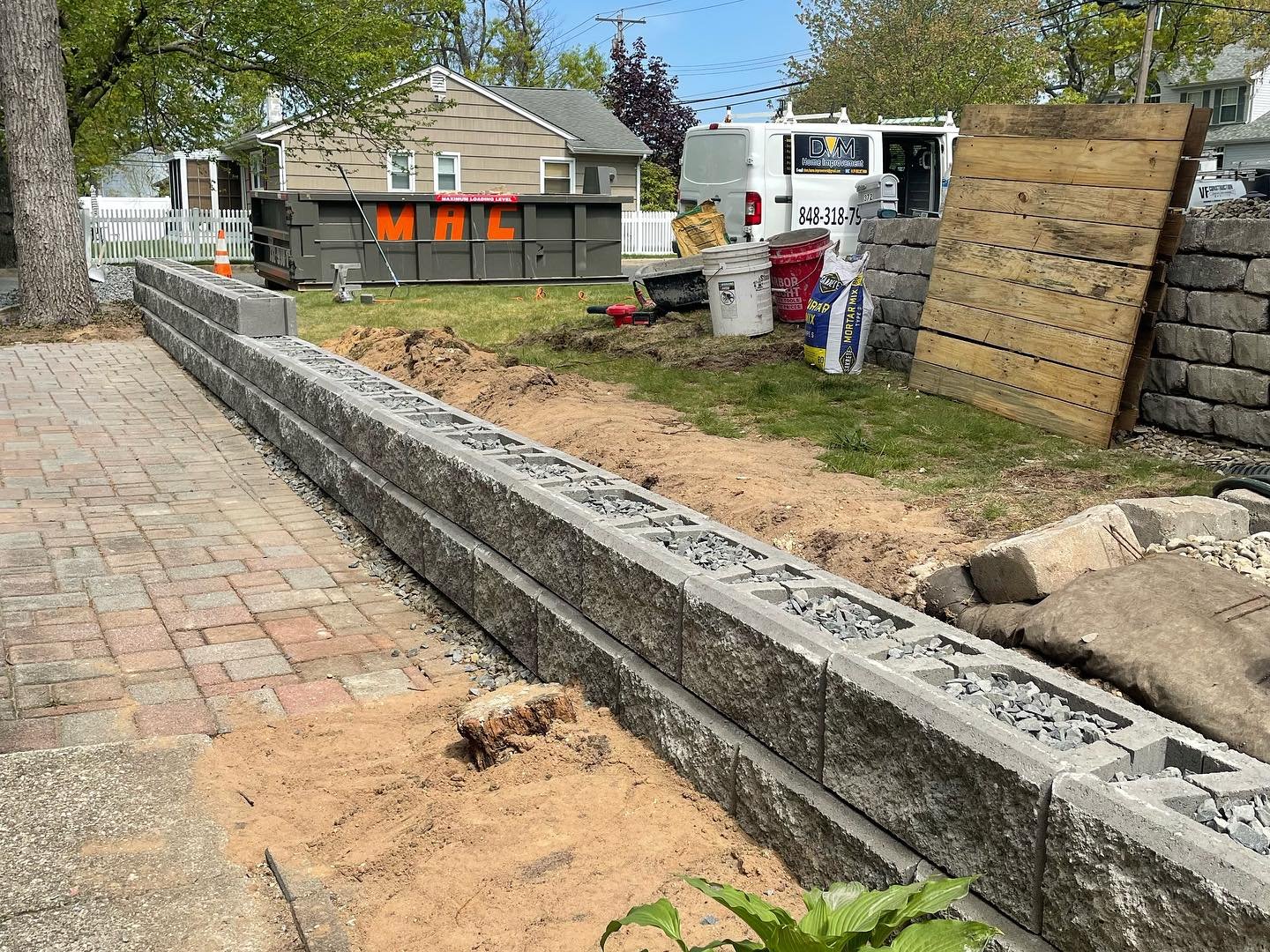 The block wall from the opposite direction, with crushed stone visible within the cores and the top still uncapped.